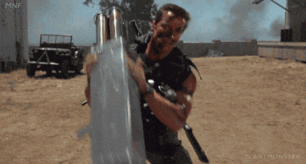 An action-movie character carrying a rocket launcher at a gender reveal